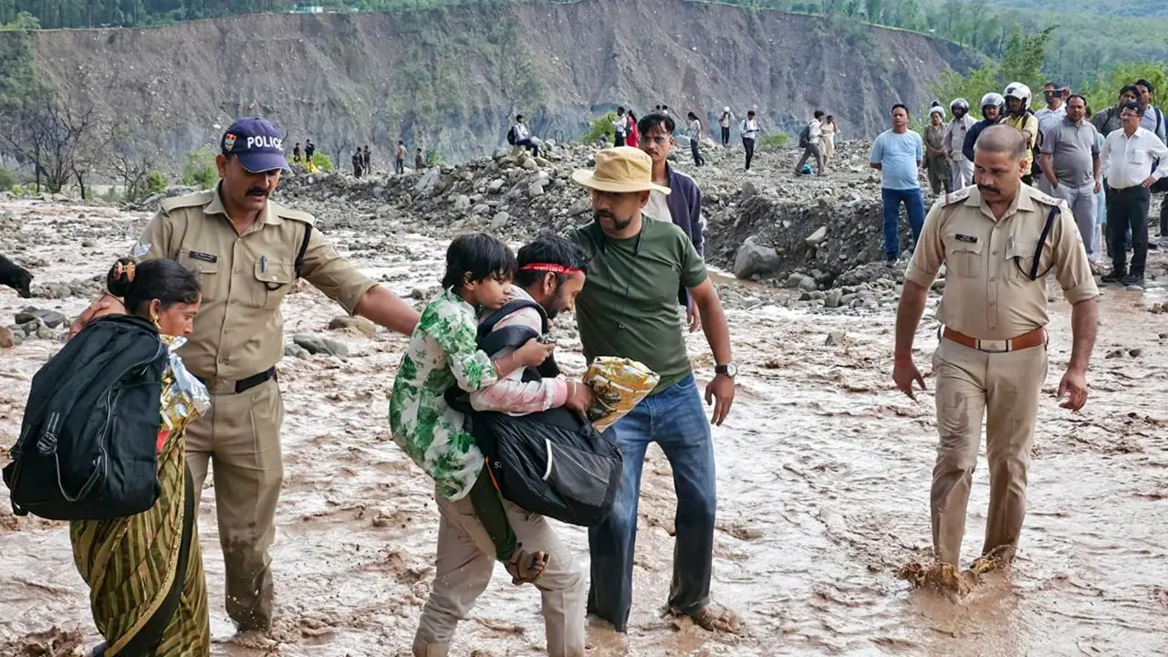 Uttarakhand: Major disaster averted during ‘Jod Mela’, SDRF personnel rescue over 50 stranded devotees Police personnel rescue pilgrims from a swollen river following heavy rainfall in Uttarakhand. Pic/PTI